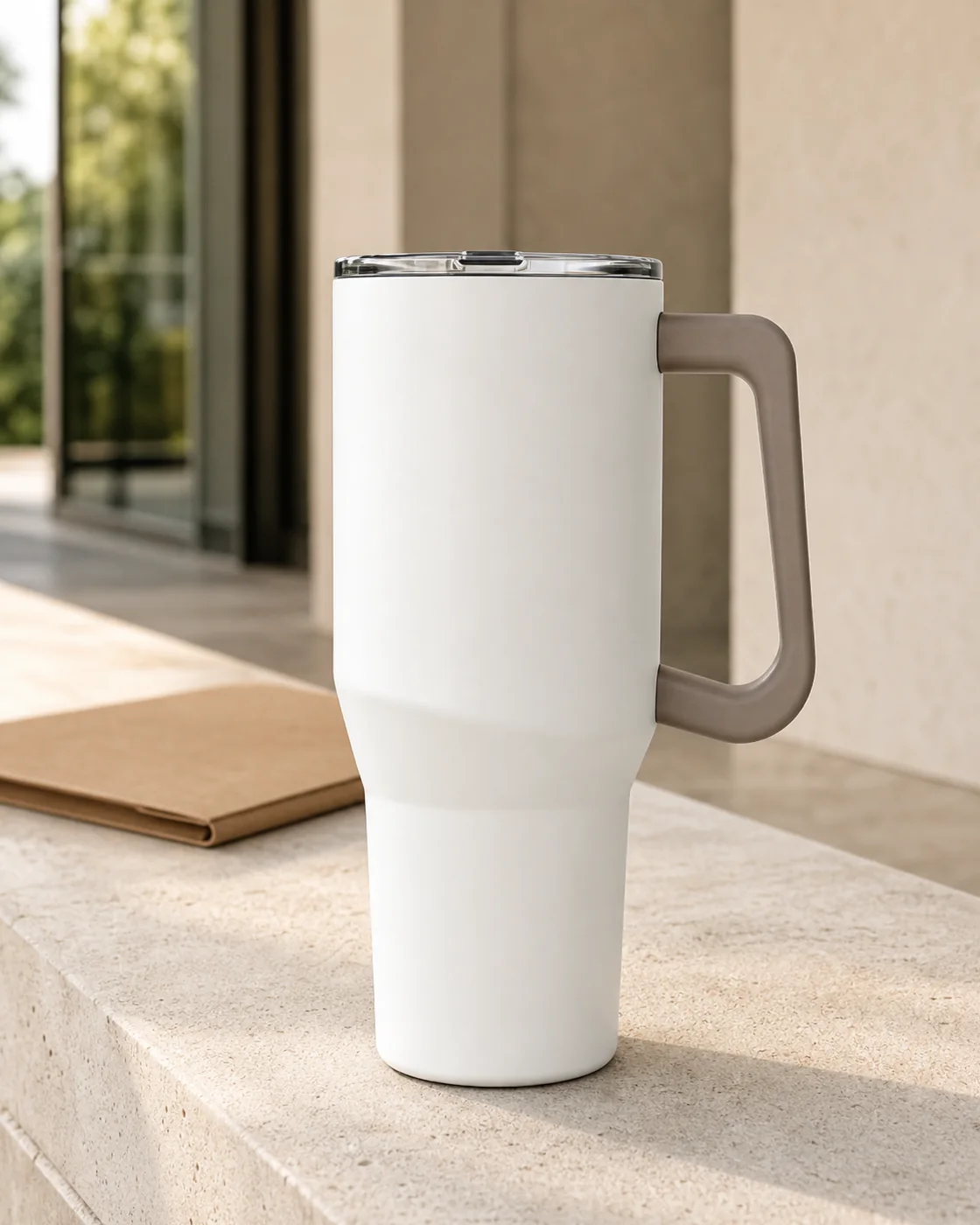 White handled tumbler on a stone ledge in morning light